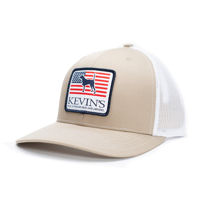 Tan and white Richardson 112 trucker cap featuring a Kevin's pointer dog and American flag patch on the front.