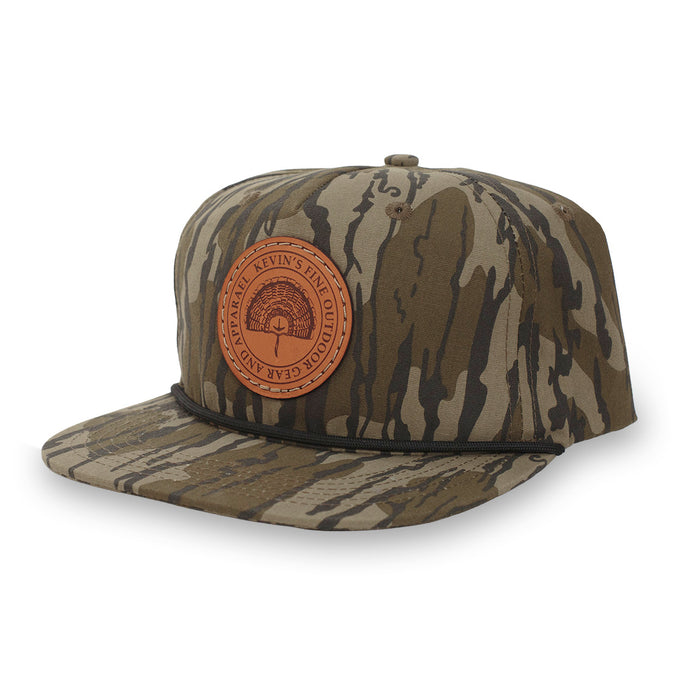 Camo cotton rope cap featuring a round leather patch with a turkey fan design and a structured mid-crown fit.