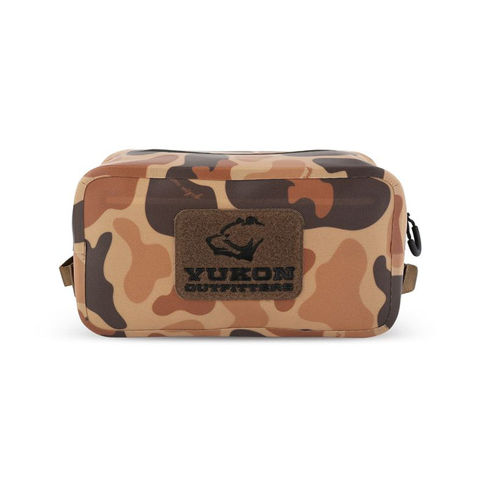 Camo Yukon Outfitters Dry Diddy pack with a durable TPU shell, water-resistant zipper, and front Velcro patch field.