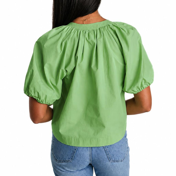 Back view of a green cotton poplin Henley top with draped puff sleeves and elastic cuffs on a white background.