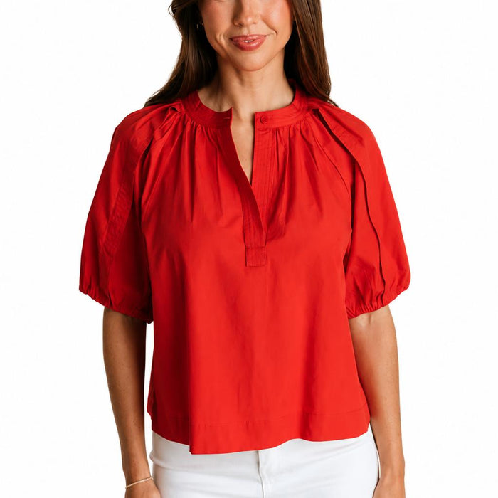 Red cotton poplin Henley top with draped short sleeves, elastic cuffs, and an open neckline.