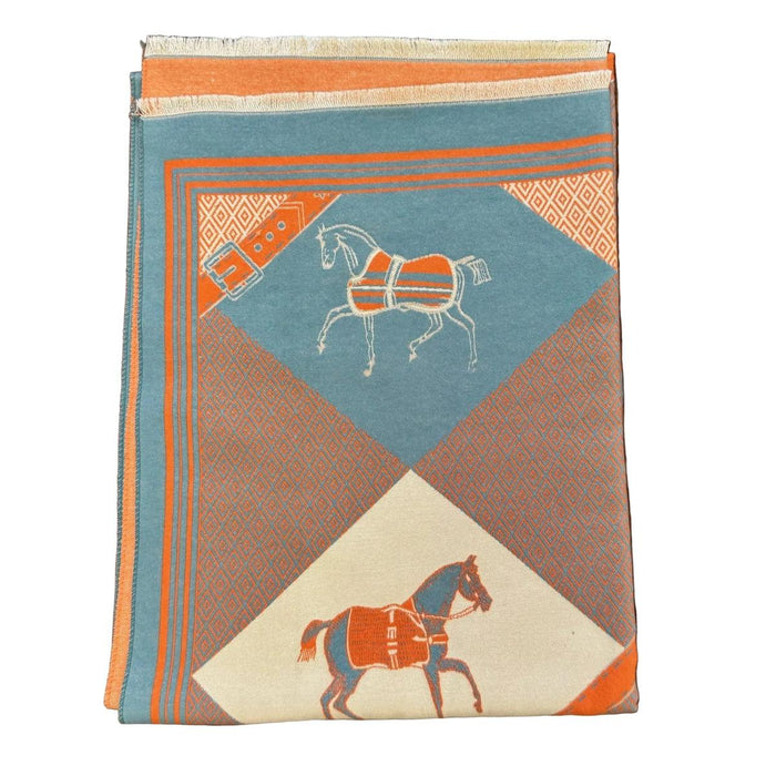 Blue and orange equestrian wrap with horse and buckle motifs in a soft, cashmere-like acrylic fabric.