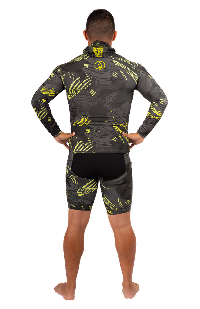Male model seen from behind wearing the Waihana Lime Fishbone Hooded Spearfishing Rashguard with long sleeves and a built-in hood, paired with matching grey and yellow-green fishbone-print shorts, on a white studio background.