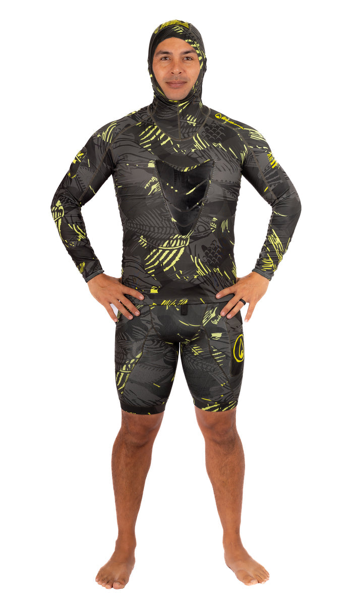 Male model wearing the Waihana Lime Fishbone Hooded Spearfishing Rashguard with matching shorts, featuring a bold black and yellow-green fishbone camouflage print and integrated hood, shown from the front on a white background.