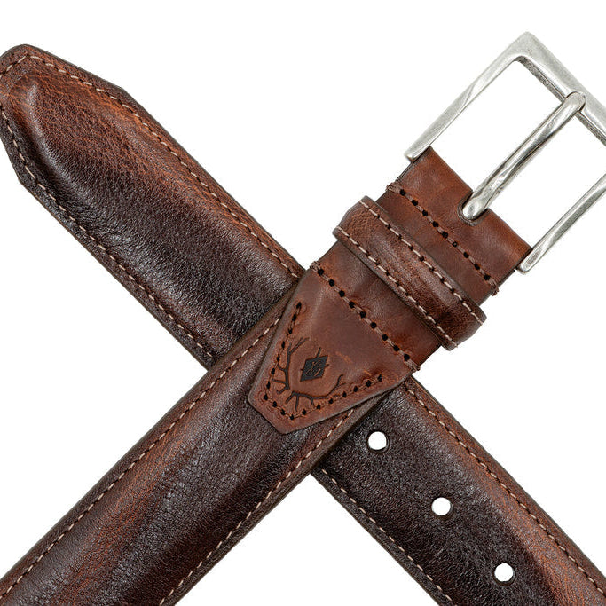 Brown shrunken Italian leather belt with antique silver buckle and detailed stitching on a white background.