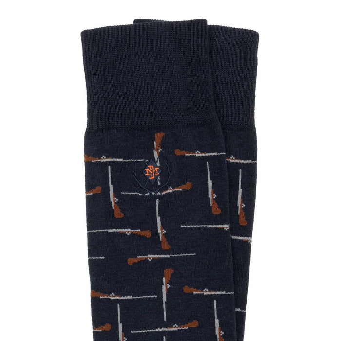 Navy blue Peruvian Pima cotton boot socks with a repeating shotgun pattern and embroidered logo detail.