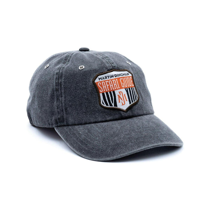 Charcoal grey cotton twill 6-panel cap with a Martin Dingman Safari Guide patch and metal eyelets.