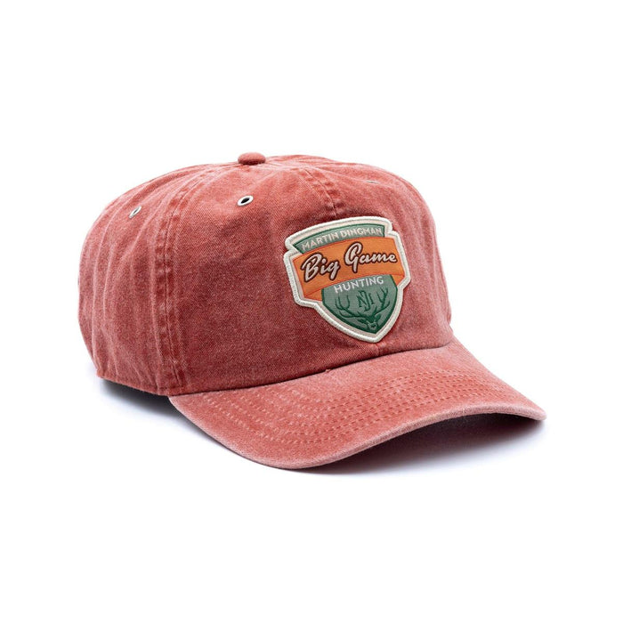 Red cotton twill 6-panel country cap with a Big Game Hunting patch and metal eyelets on a white background.