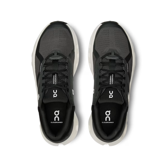 Top-down view of black and grey On Running Cloudrunner 2 sneakers with breathable mesh and cushioned white soles.