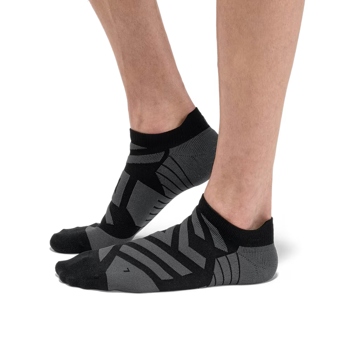 Black and grey On Running low-cut performance socks featuring technical mesh panels and targeted arch support.