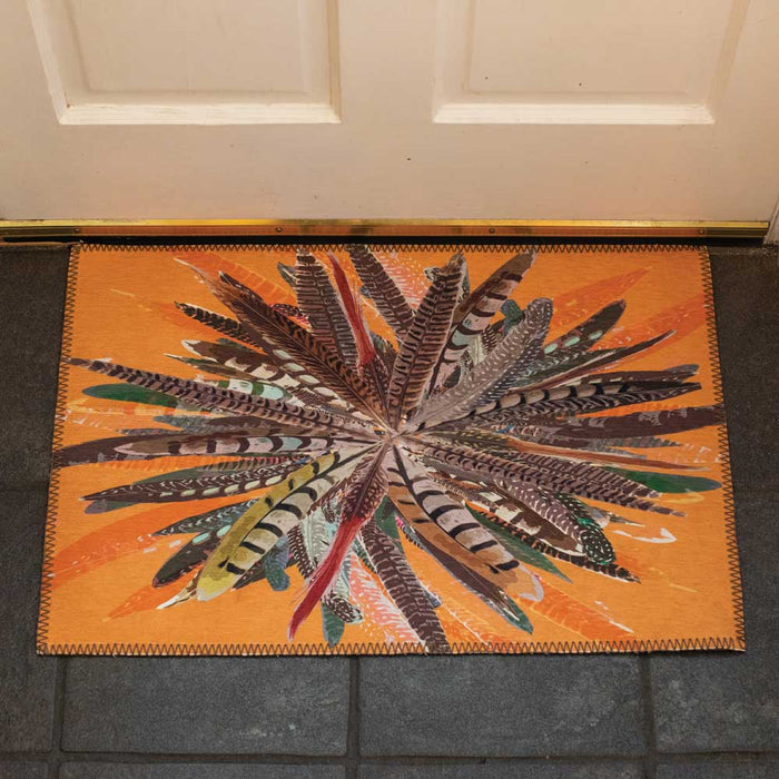 Orange chenille door mat featuring a vibrant, starburst pheasant feather pattern in a 20x30 inch low-profile design.