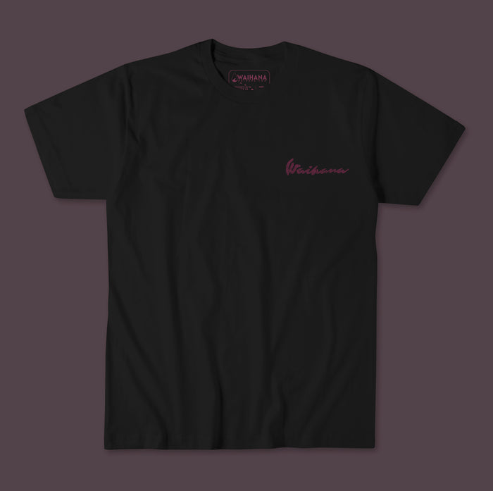 Waihana Pink Fishbone Premium Pima T-Shirt in Driftwood Black with a tonal maroon script logo on the left chest, shown flat against a dark purple background.