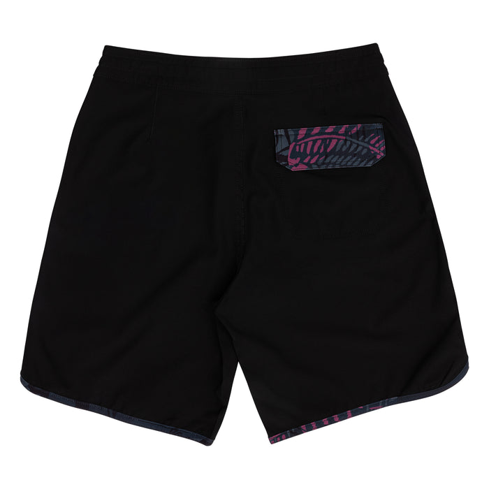 Rear view of Waihana Pink Fishbone W1 board shorts in black with a tropical pink fishbone print back pocket and matching hem trim, displayed on a white background.