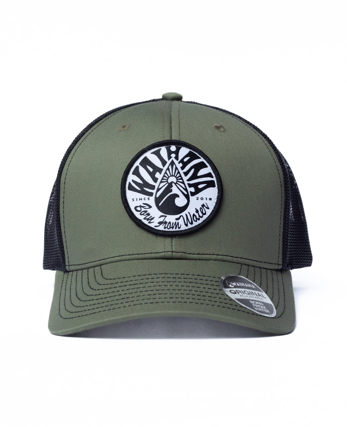 Ranger green and black mesh Waihana Mauka Trucker hat featuring a circular woven patch with the Waihana logo and 'Born From Water Since 2018' text, shown on a white background.