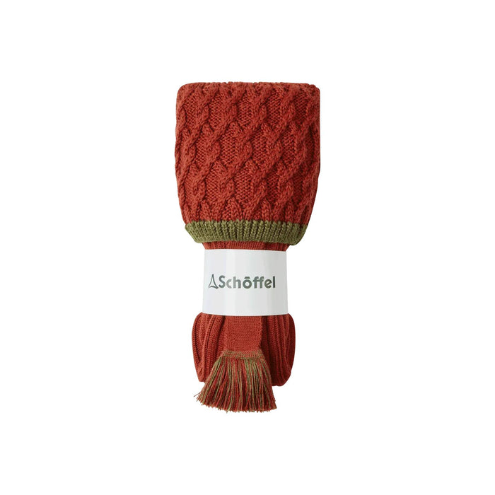 Rust-colored Schöffel merino wool hunting socks with a cable-knit cuff, green trim, and matching decorative garter tassel.