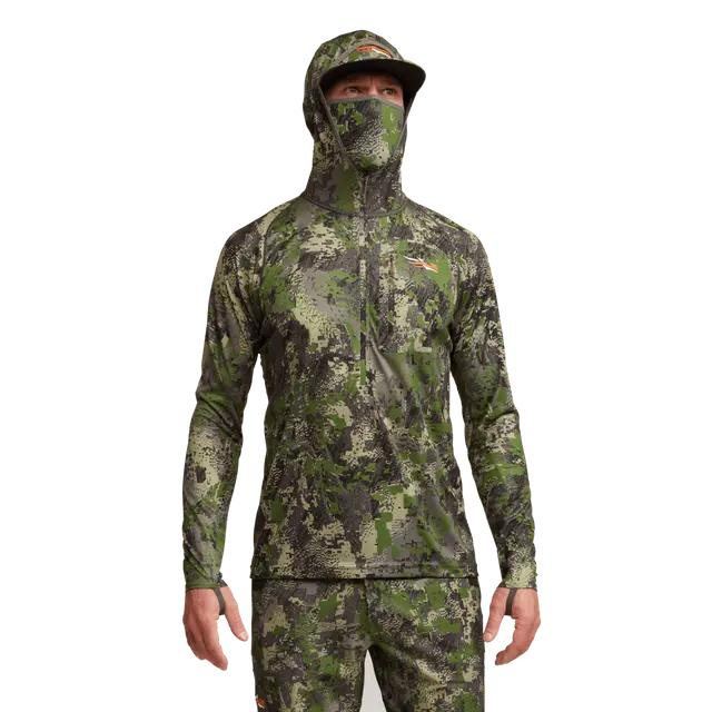 Sitka Core Lightweight Hoody in camouflage print with integrated face mask, hood, and thumb loops on a hunter.