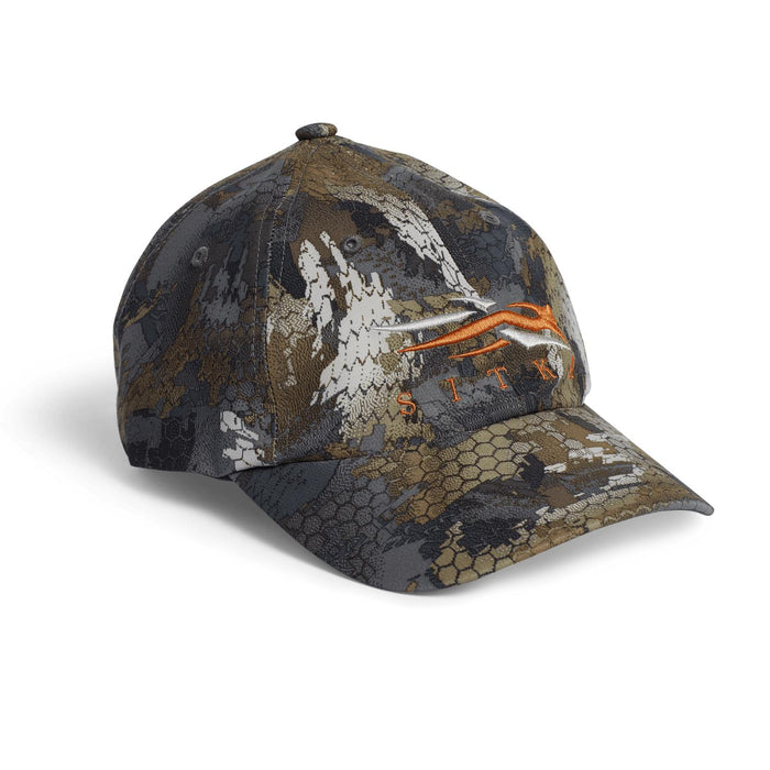 Sitka Traverse cap in camo print with an orange and white embroidered logo on a durable, water-repellent polyester blend.
