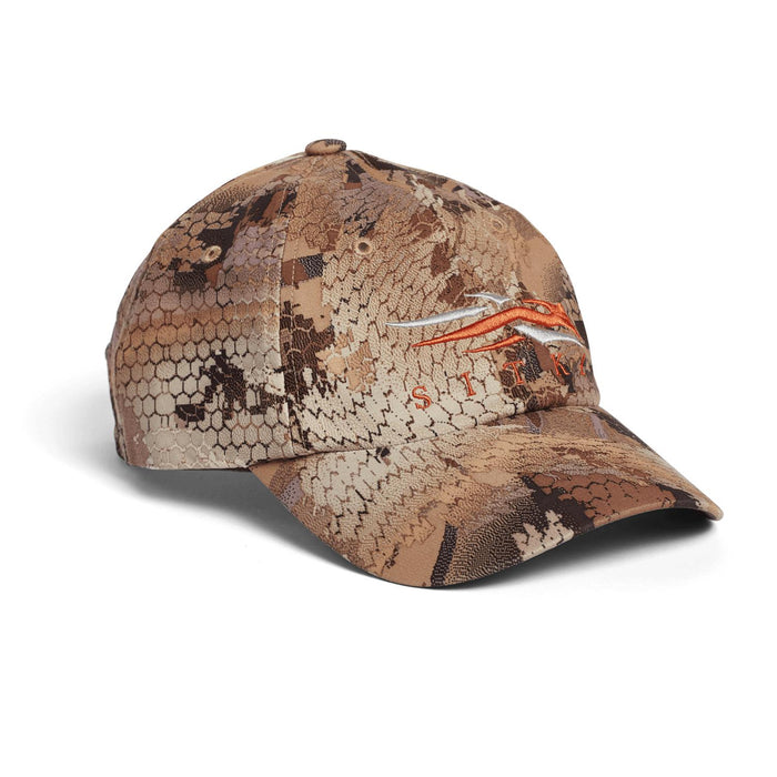 Sitka Traverse cap in brown camouflage pattern with an embroidered orange logo on the front.