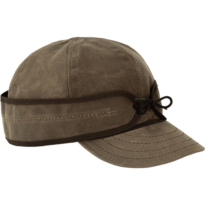 Dark oak waxed cotton Stormy Kromer cap with six-panel crown, stitched brim, and adjustable pulldown earband.