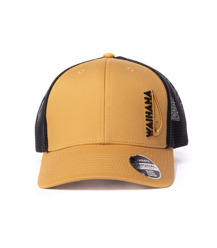 Waihana Sunset Beach Trucker hat in gold with black mesh back, featuring embroidered Waihana branding and speargun logo on the front panel.