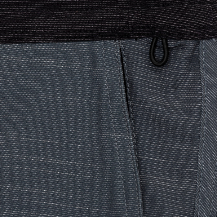 Close-up of Waihana Tidal Moss Cruiser Board Shorts showing textured dark grey fabric, panel stitching, and black drawstring at the waistband.