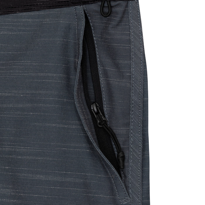 Close-up of the zippered side pocket on the Waihana Tidal Moss Cruiser board shorts, featuring a black zipper and dark grey ripstop-style striped fabric.