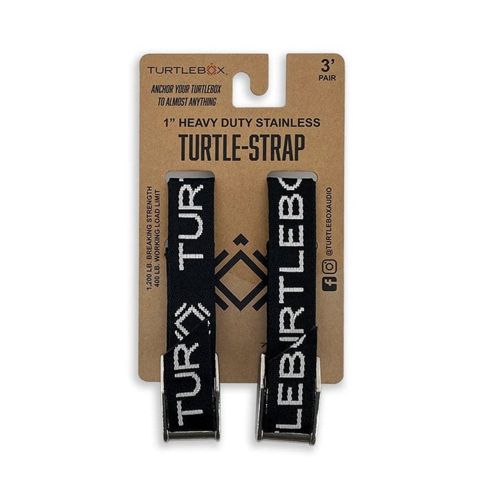 Two black Turtlebox heavy-duty tie-down straps with stainless steel buckles on branded cardboard packaging.