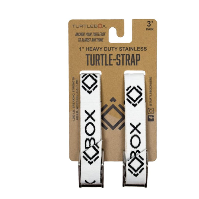 Two white Turtlebox heavy-duty tie-down straps with black geometric patterns and stainless steel buckles on a display card.