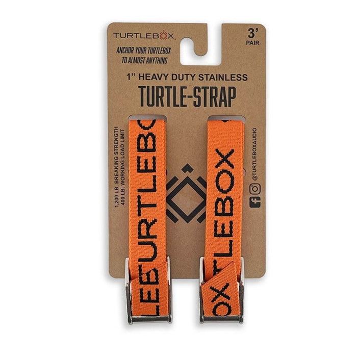 Two orange Turtlebox heavy-duty tie-down straps with stainless steel buckles on retail display packaging.