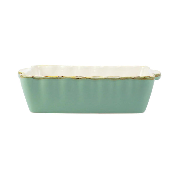 Small rectangular Italian stoneware baker in sage green with scalloped edges and a rustic, artisan finish.