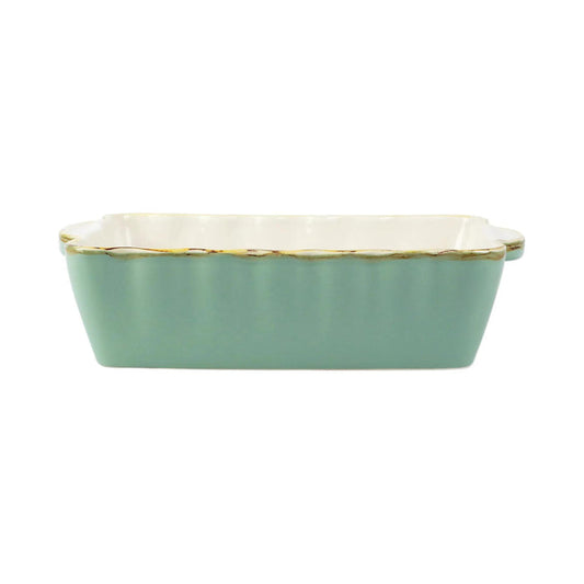 Small rectangular Italian stoneware baker in sage green with scalloped edges and a rustic, artisan finish.