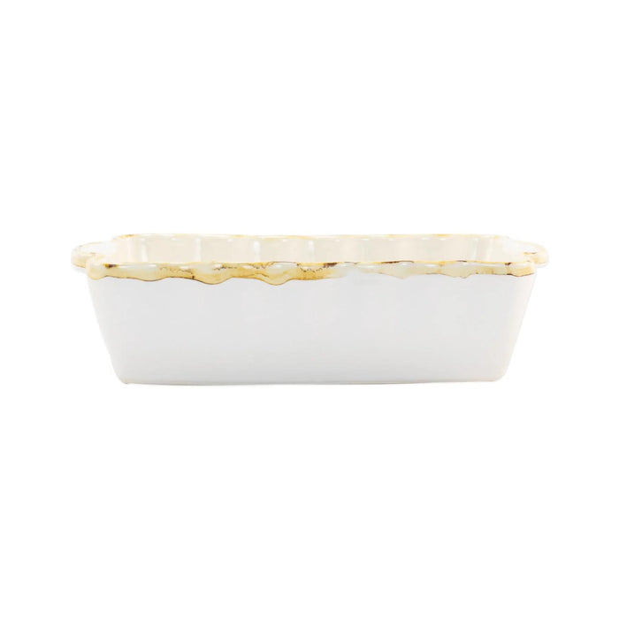 White rectangular Italian stoneware baker with scalloped edges and rustic brown detailing, 9.75 inches long.