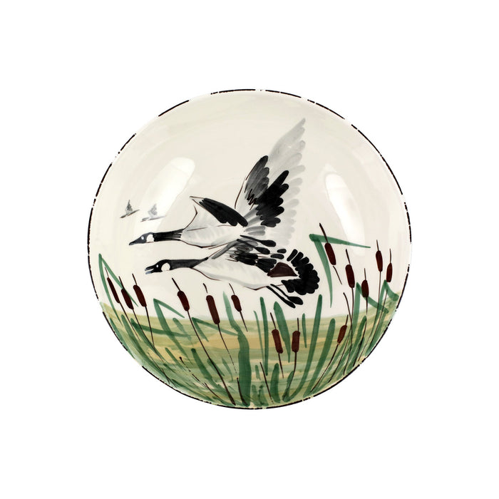 Handpainted 11-inch ceramic serving bowl featuring a geese motif in a marsh landscape, crafted in Tuscany.
