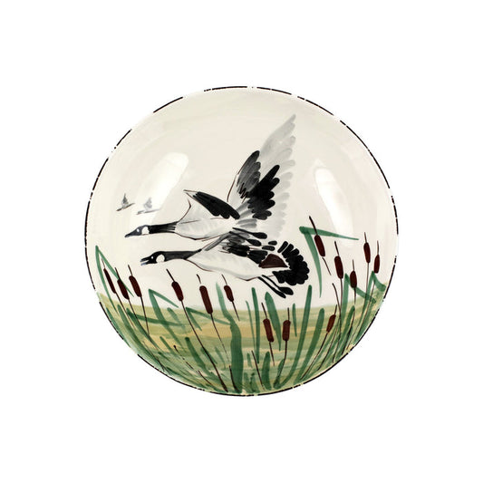 Handpainted 11-inch ceramic serving bowl featuring a geese motif in a marsh landscape, crafted in Tuscany.