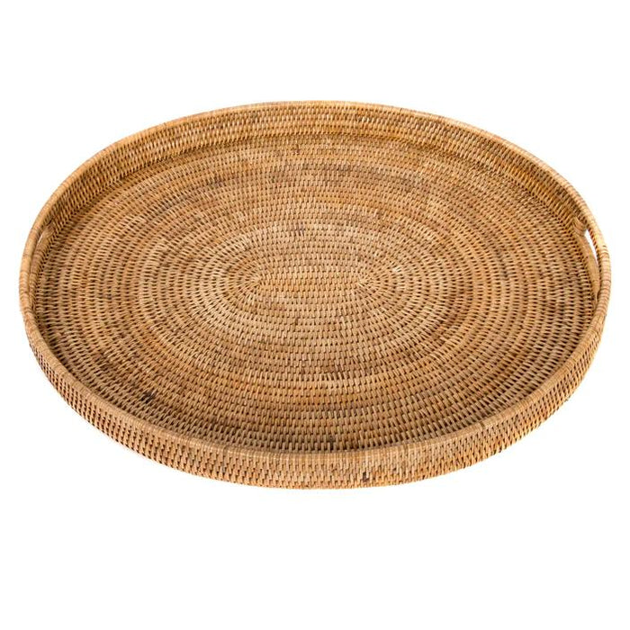 Handmade oval rattan ottoman tray in natural light brown with integrated cutout handles on a white background.