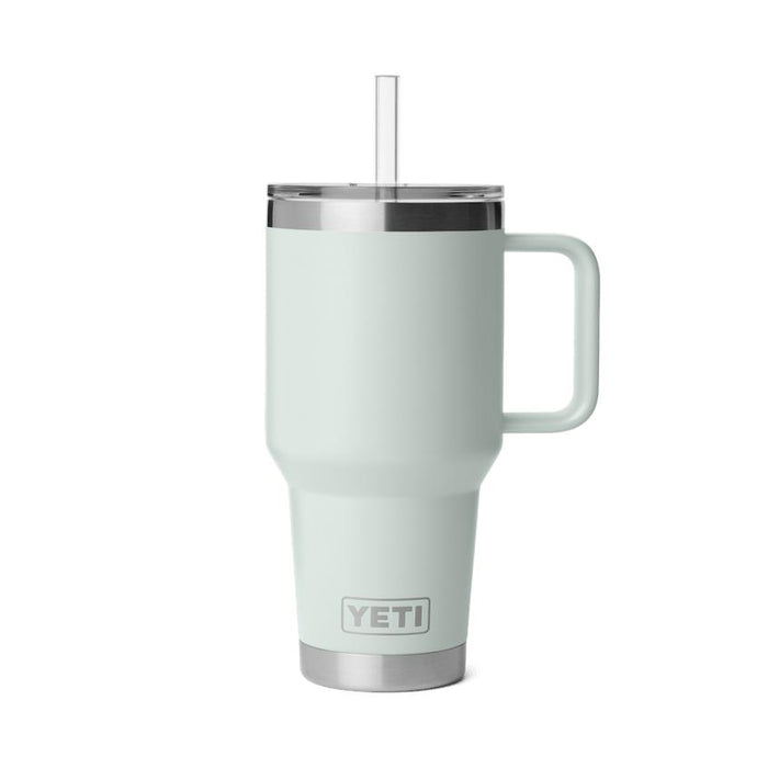 Sage green YETI Rambler 35 oz insulated mug with a handle, clear straw, and stainless steel base on a white background.