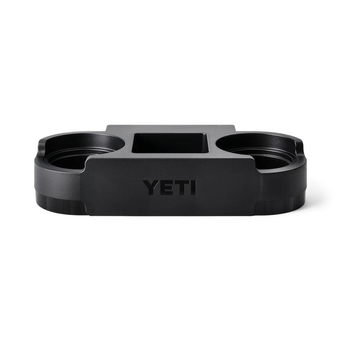 Black YETI Roadie cooler cup caddy with two drink holders and a central storage compartment for small essentials.
